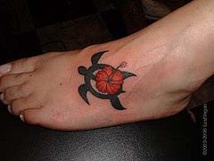 Flower on tribal turtle tattoo