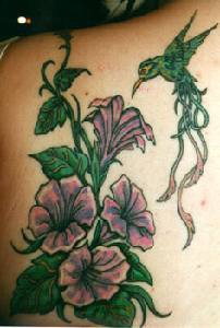 Purple flowers and green humminbird tattoo