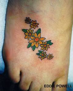 Yellow flowers tattoo on foot