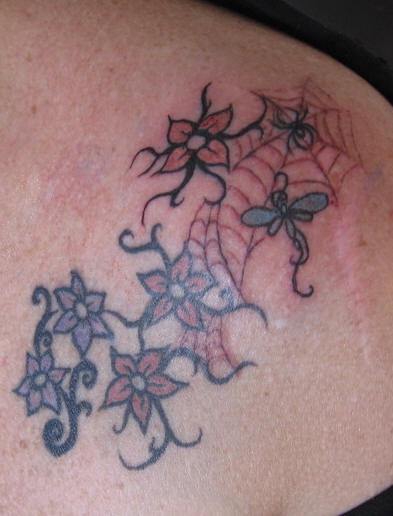 Flower shoulder tattoo, many, little flowers in net, spider, dragon-fly