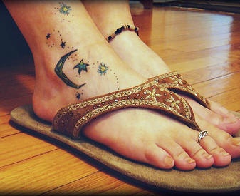 Thin moon & decorated stars foot tattoo
