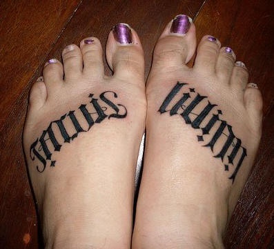 Black styled with little rhombs inscription foot tattoo