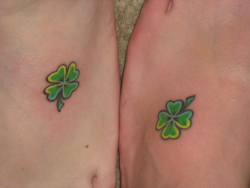 Two green little juicy leaves foot tattoo