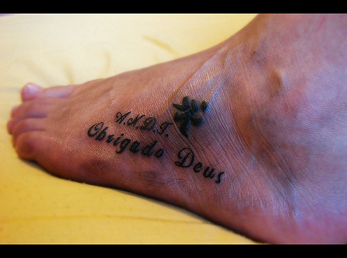Ciphered inscription and full name foot tattoo