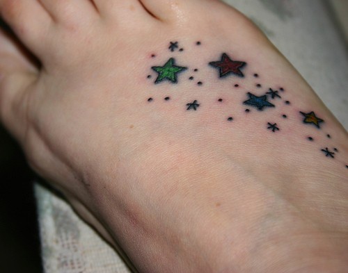 Many-coloured stars and dots foot tattoo