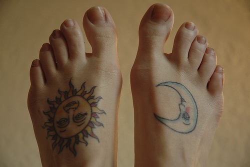 Sun & moon characters similar size foot tattoo