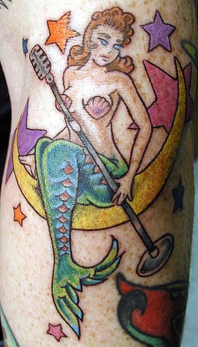 Mermaid-singer, sitting on the moon forearm tattoo