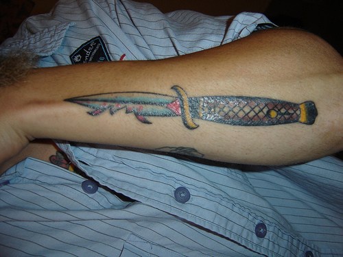 Colourful, accurate,sharp, broken penknife forearm tattoo
