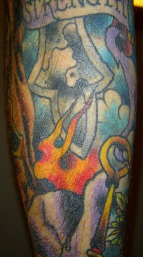 Strength ,fire, shield & stone forearm tattoo