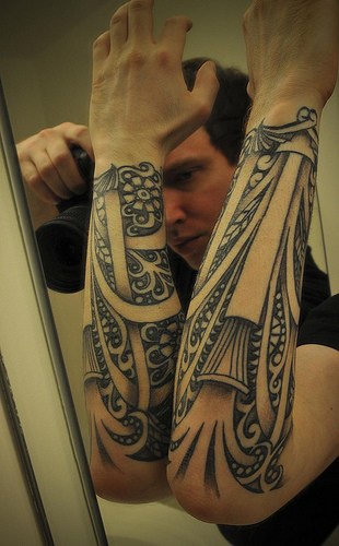 Pattern with sticks, streams & curls forearm tattoo