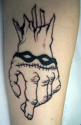 Crossed fingers on hand with bracelet forearm tattoo