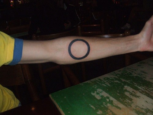 Regular black mystic circle forearm tattoo