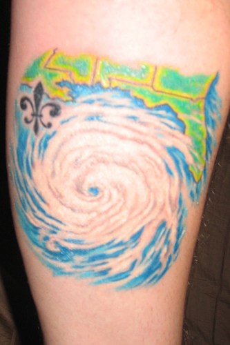 Colourful fragment of waterspout forearm tattoo