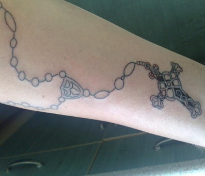Forearm rosary beads tattoo