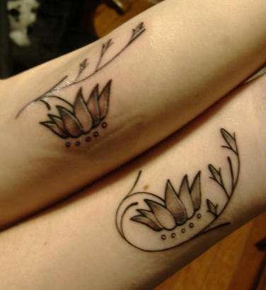 Identical friendship flower arm tattoos