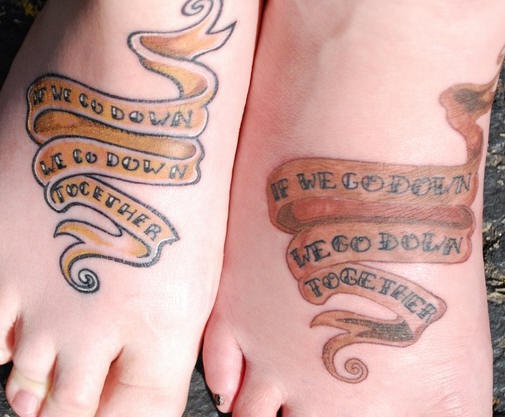 Identical stripe tattoos on friends feet