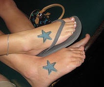 Identical star tattoos on friends feet