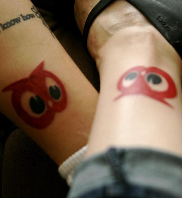 Identical owl tattoos on friends