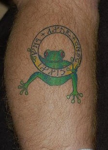 Frog with golden ring tattoo on leg
