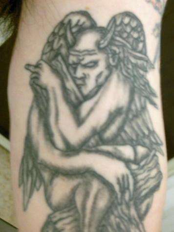 Gargoyle hugs black ink tattoo