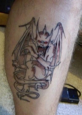 Bloody gargoyle tattoo on leg