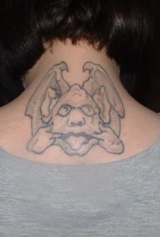 Gargoyle grimace tattoo on neck