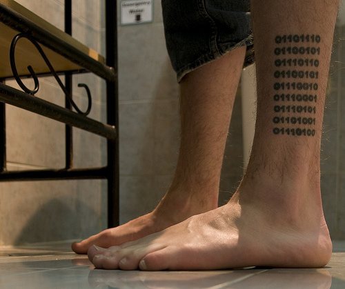 Binary code tattoo on leg