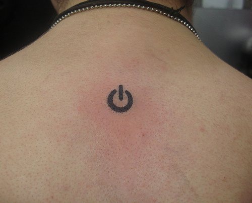 Power on button tattoo  on back