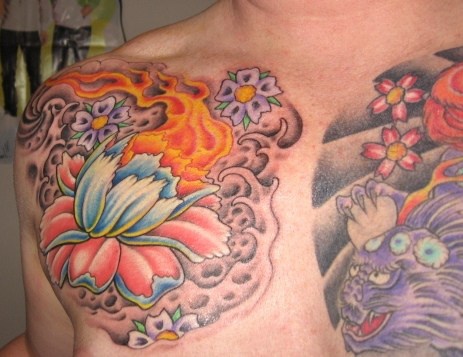 White lotus and purple dragon tattoo on chest