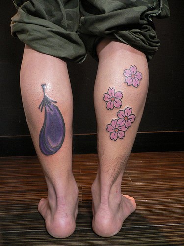 Eggplant and flowers tattoos on both legs