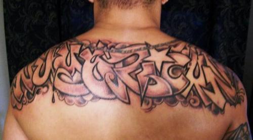 Graffiti tag tattoo on both shoulders