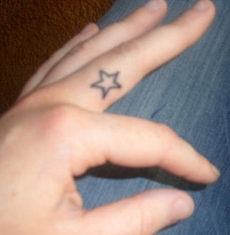 Tiny empty, simple colorless star hand tattoo