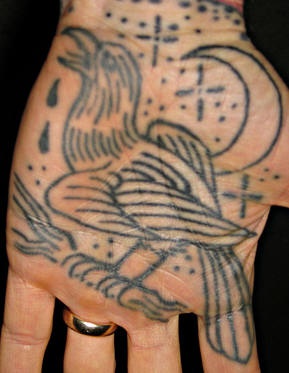 Crying bird near moon & stars hand tattoo
