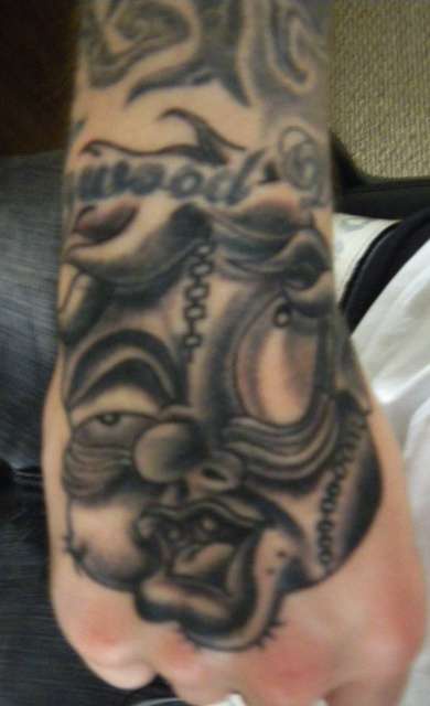 Tatuaje en la mano, monstruo repugnante con labios y ojos grandes