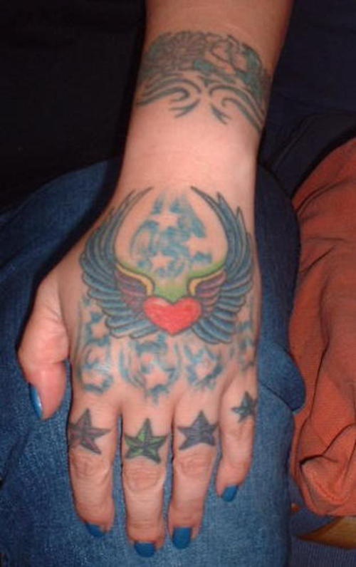 Flying winged heart, many stars  hand tattoo