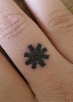 Black, bold snowflake sign hand tattoo