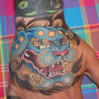 Blue angry dog with sharp teeth  hand tattoo
