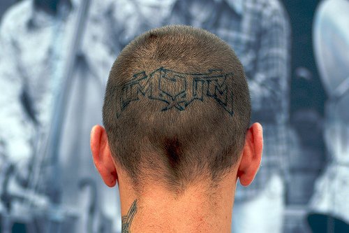 Head tattoo, blue designed inscription