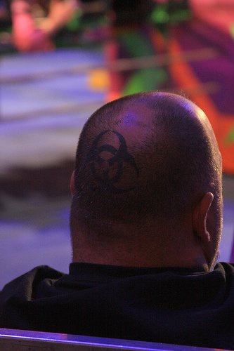 Head tattoo with four black crossed circles