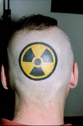 Round, black & yellow fan head tattoo