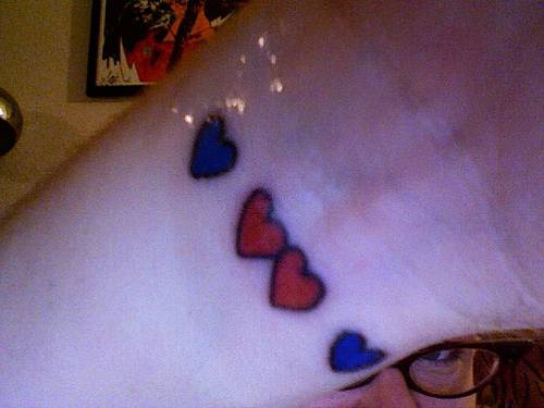 Blue and red hearts wrist tattoo