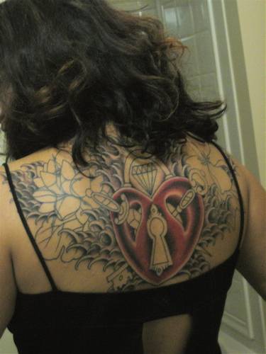 Large incomplete heart themed tattoo on back