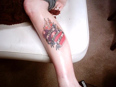 Two flaming hearts leg tattoo