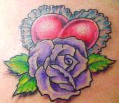 Heart with tracery and flower tattoo