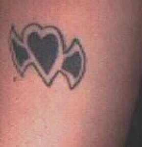 Black heart shaped axe tattoo