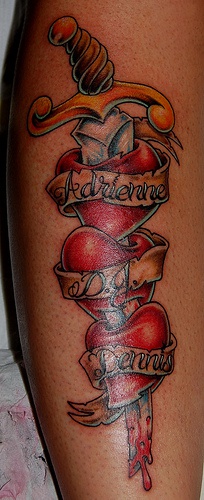 Three hearts on dagger tattoo