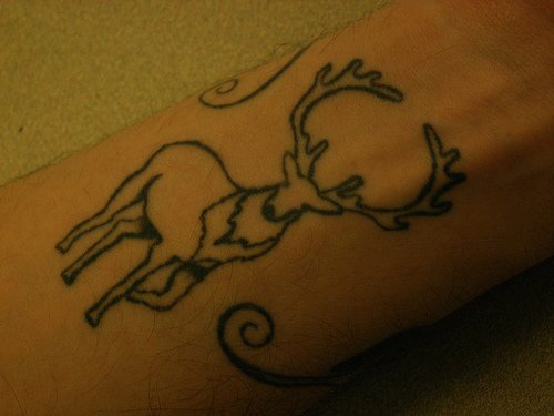 Black deer tattoo on wrist