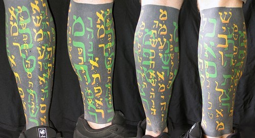 Hebrew writings full leg tattoo