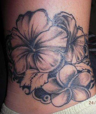 Black ink hibiscus tattoo on lower back