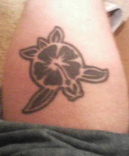Turtle with flower of hibiscus tattoo